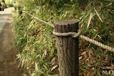 Wooden posts with cable or rope.