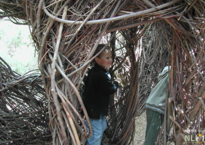 children playing in structure made from loose parts