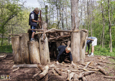 children building a log fort