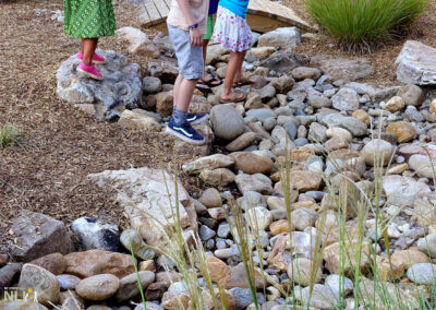 children playing in a dry stream bed