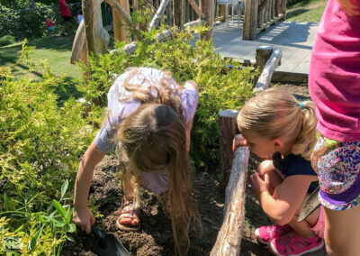 child digging in a raised planter