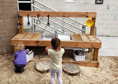 children playing in a mud kitchen