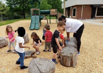 children playing around a stump circle