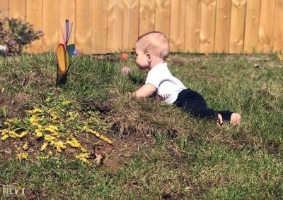 toddler on grass mound