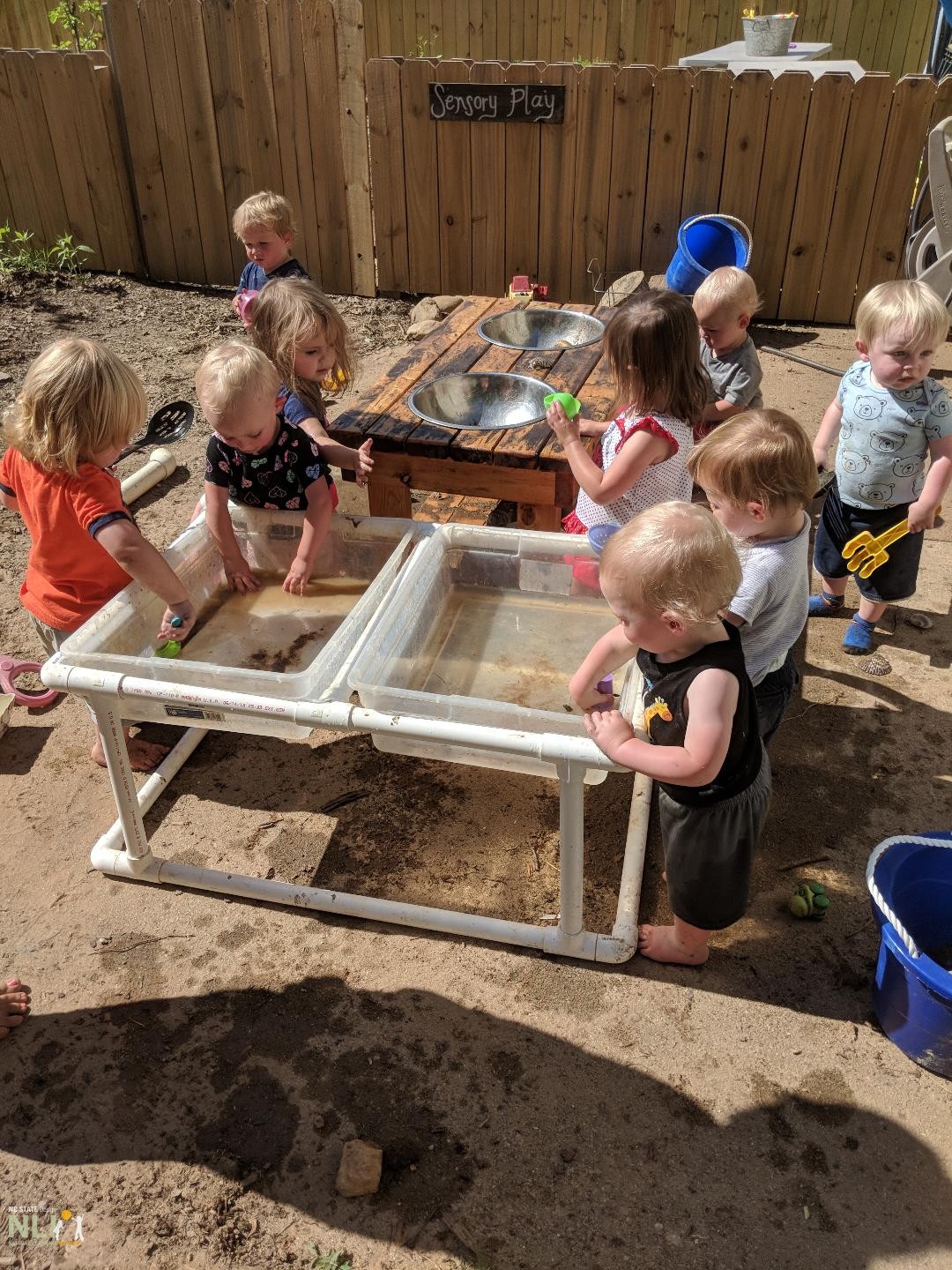 children engaging in water and mud play