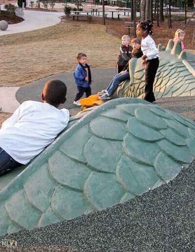 children playing at a pack with adults overseeing