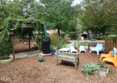 gathering setting showing a raised bed and rain barrel