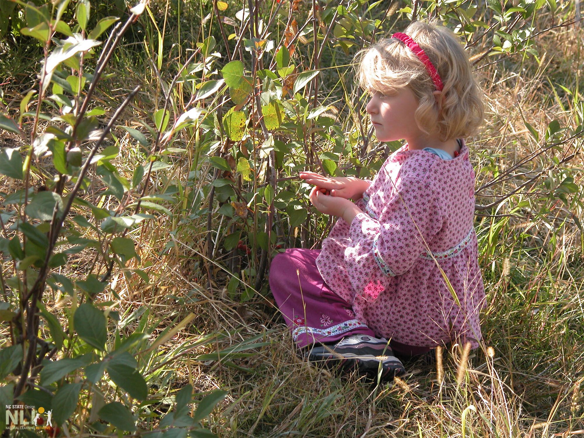 child observing plants