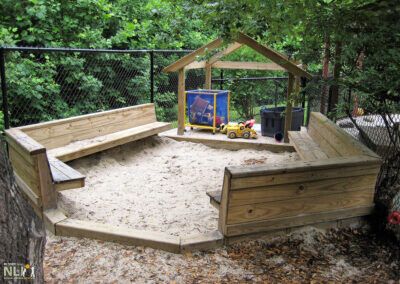 sand play area with built in benches