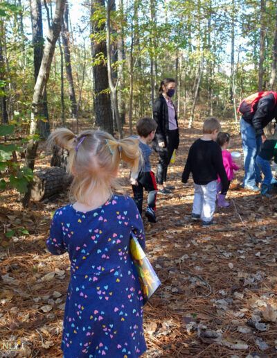 teachers leading children through a trail