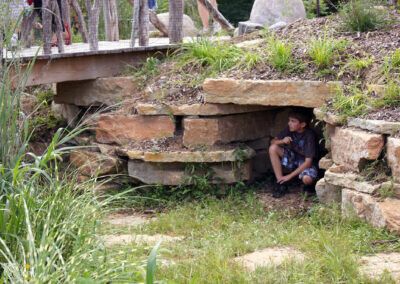 child playing and hiding in a cave like structure