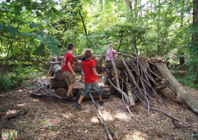 children playing in log structure