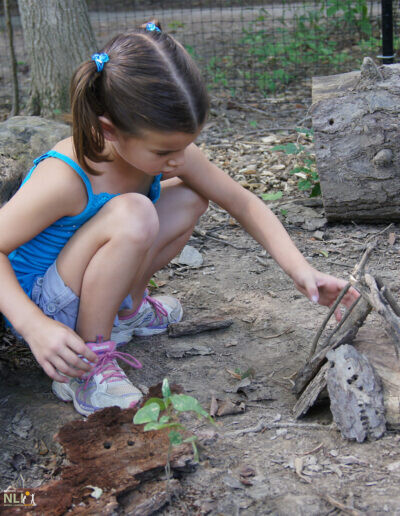 child playing with natural loose parts