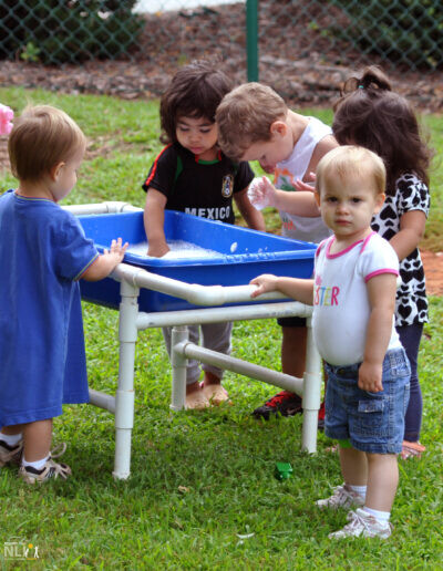 children playing in a plastic water table