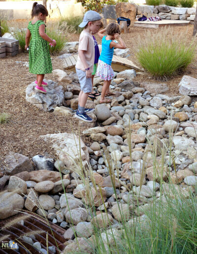 children playing in dry stream bed