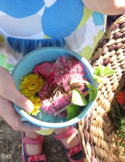 child holding container with assorted flowers