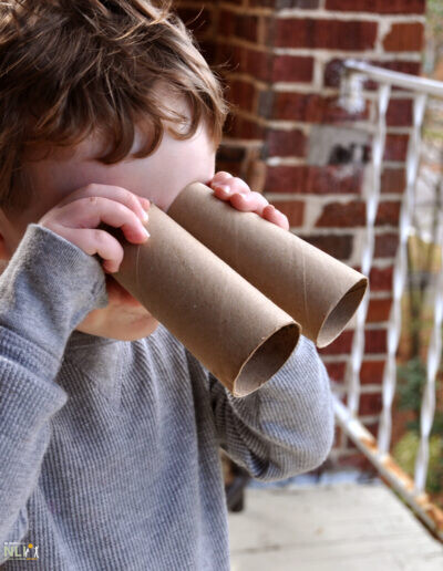 child using crafted play-binoculars