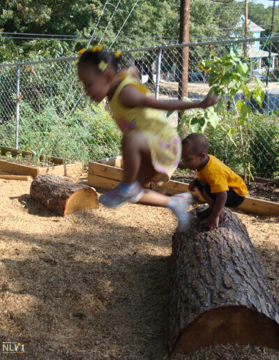 child jumping from log