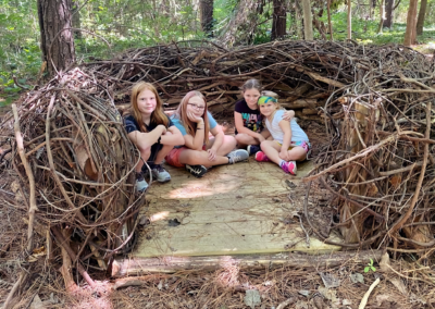 children in a created natural wooden structure