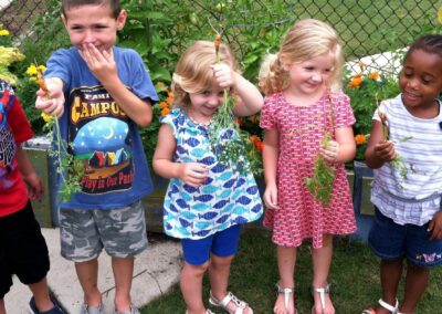 children holding harvested carrots