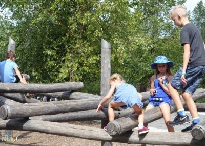 children on a wooden climbing structure