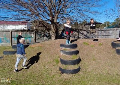 child jumping while playing on hill with built-in tires